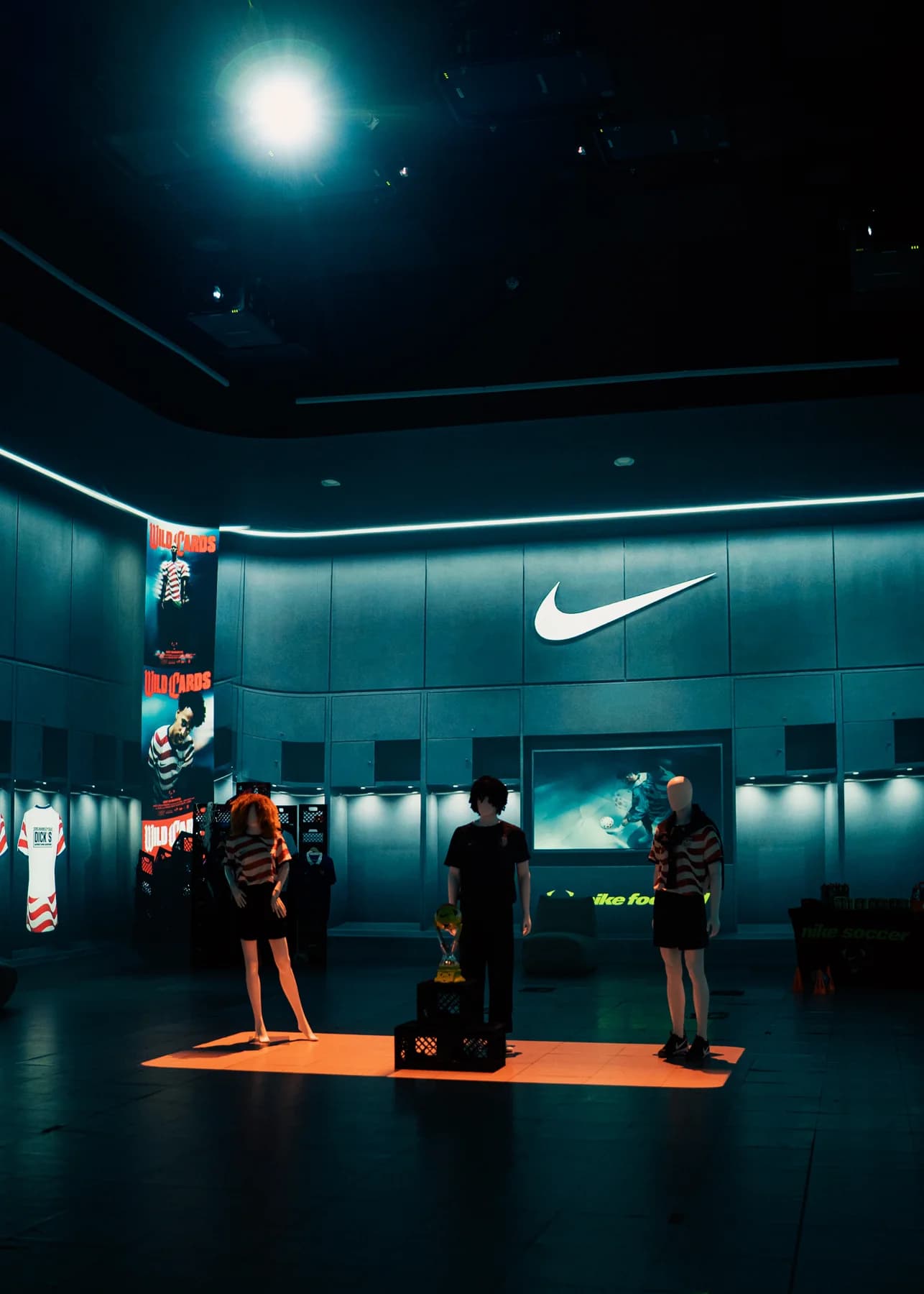Nike event space with overhead lighting and an orange display platform
